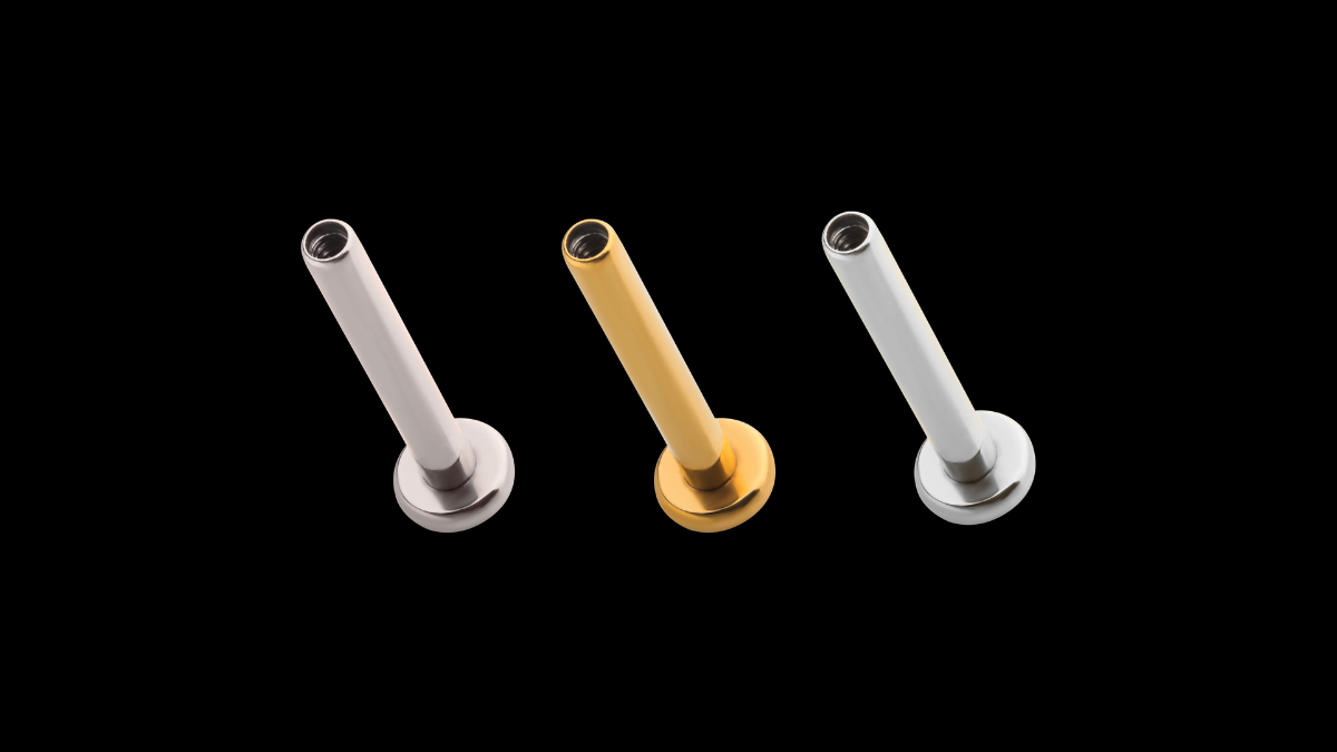Implant grade titanium, steel and solid gold labret studs shown side by side