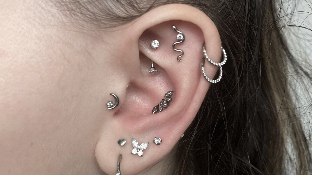 A finished curated ear showing several piercings arranged as one composition