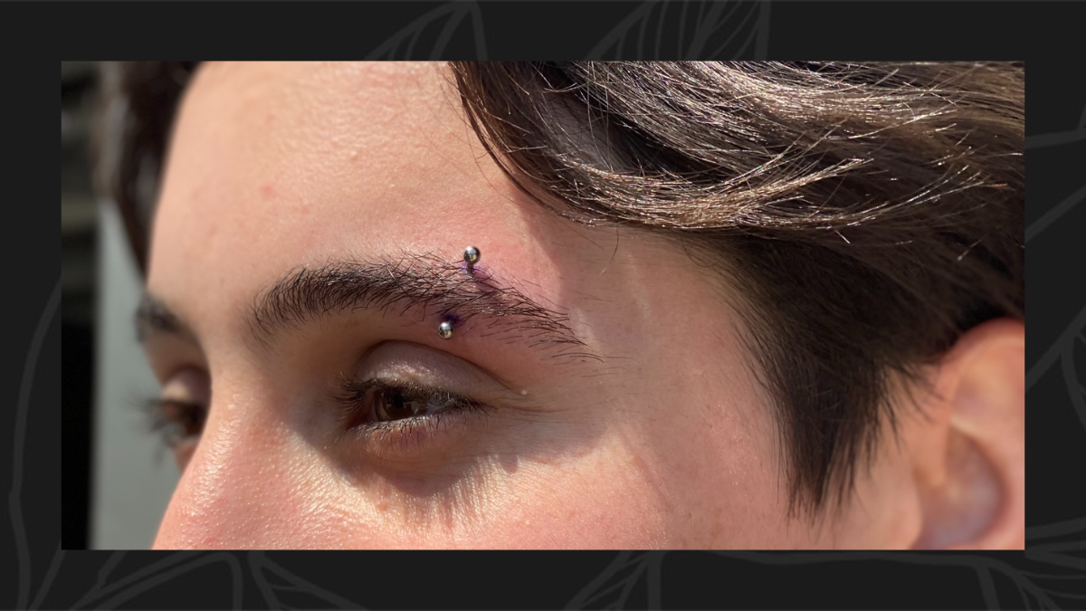 An eyebrow piercing with a curved barbell following the line of the brow 