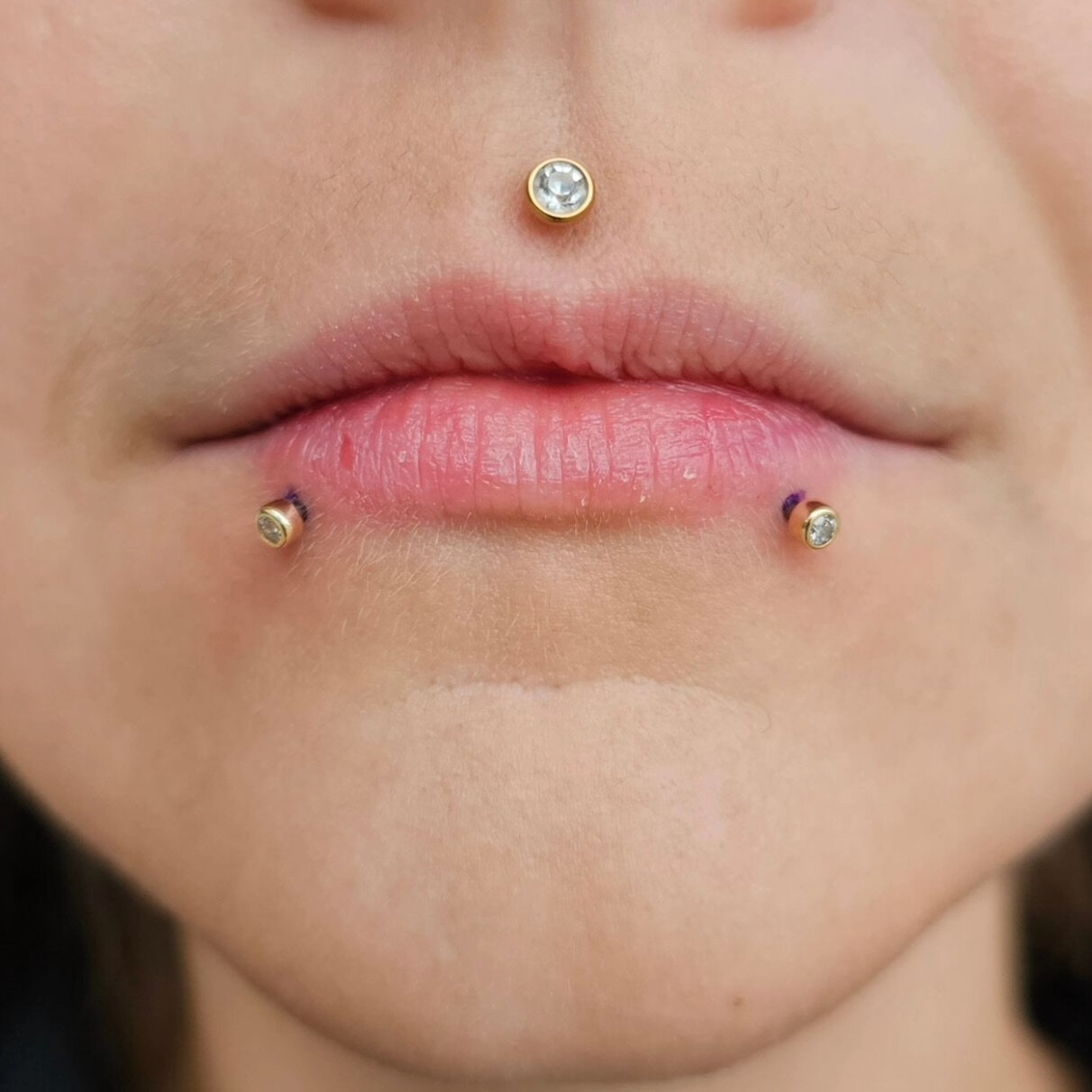 healed lip piercings with correctly fitted jewellery photographed in natural light