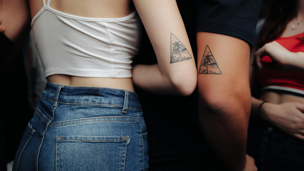 Two complementary tattoos photographed together on two different people