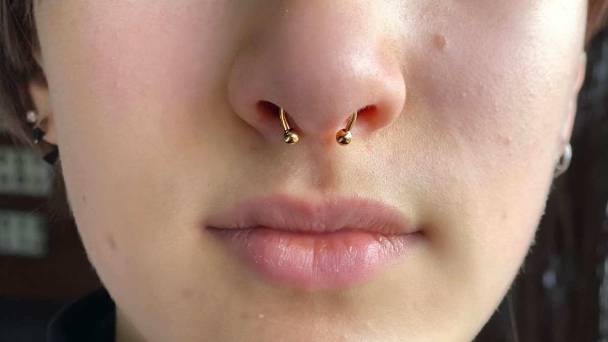 A septum piercing shown worn down