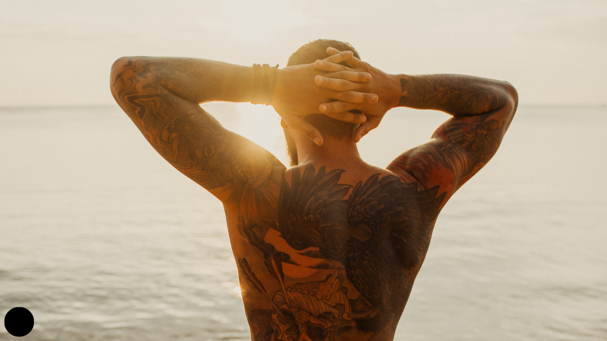  healed tattoos photographed in sunlight at the beach