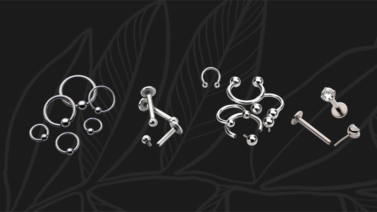 A flat lay of body jewellery grouped by type, showing studs, rings, barbells and threadless ends